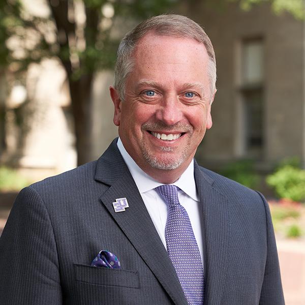 Christopher M. Pietruszkiewicz, Esq. outside on campus